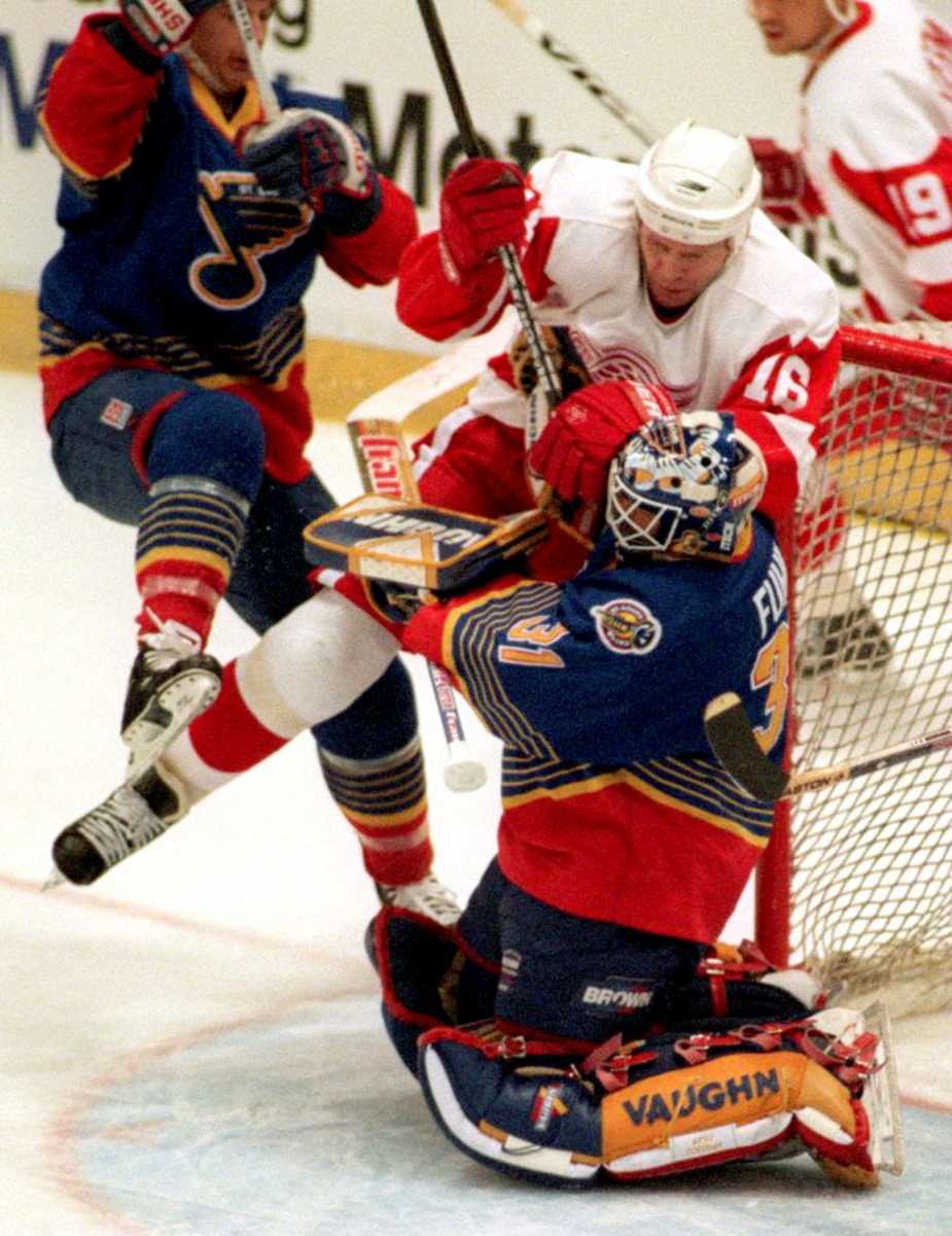 Blues goalie Grant Fuhr, #31, gets run into by Red Wing Vladimir Konstantino